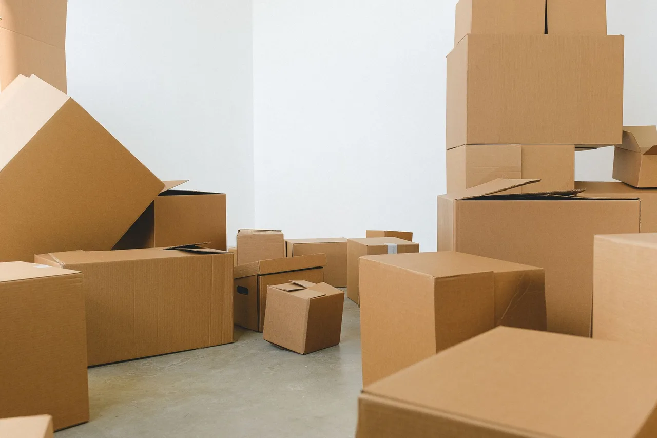Cardboard boxes awaiting removal in an empty room