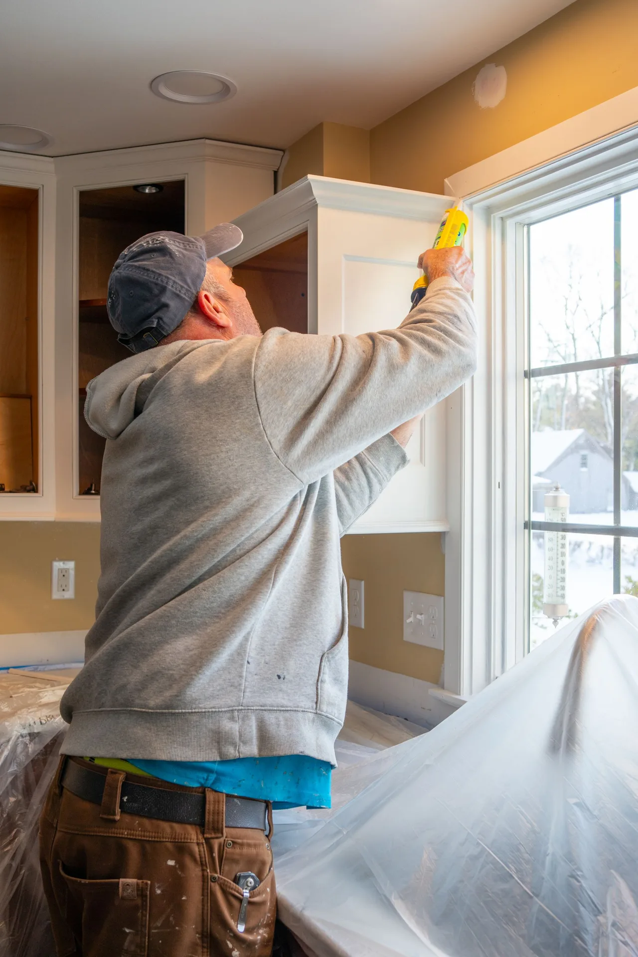 Detail work sealing cabinetry during minor maintenance